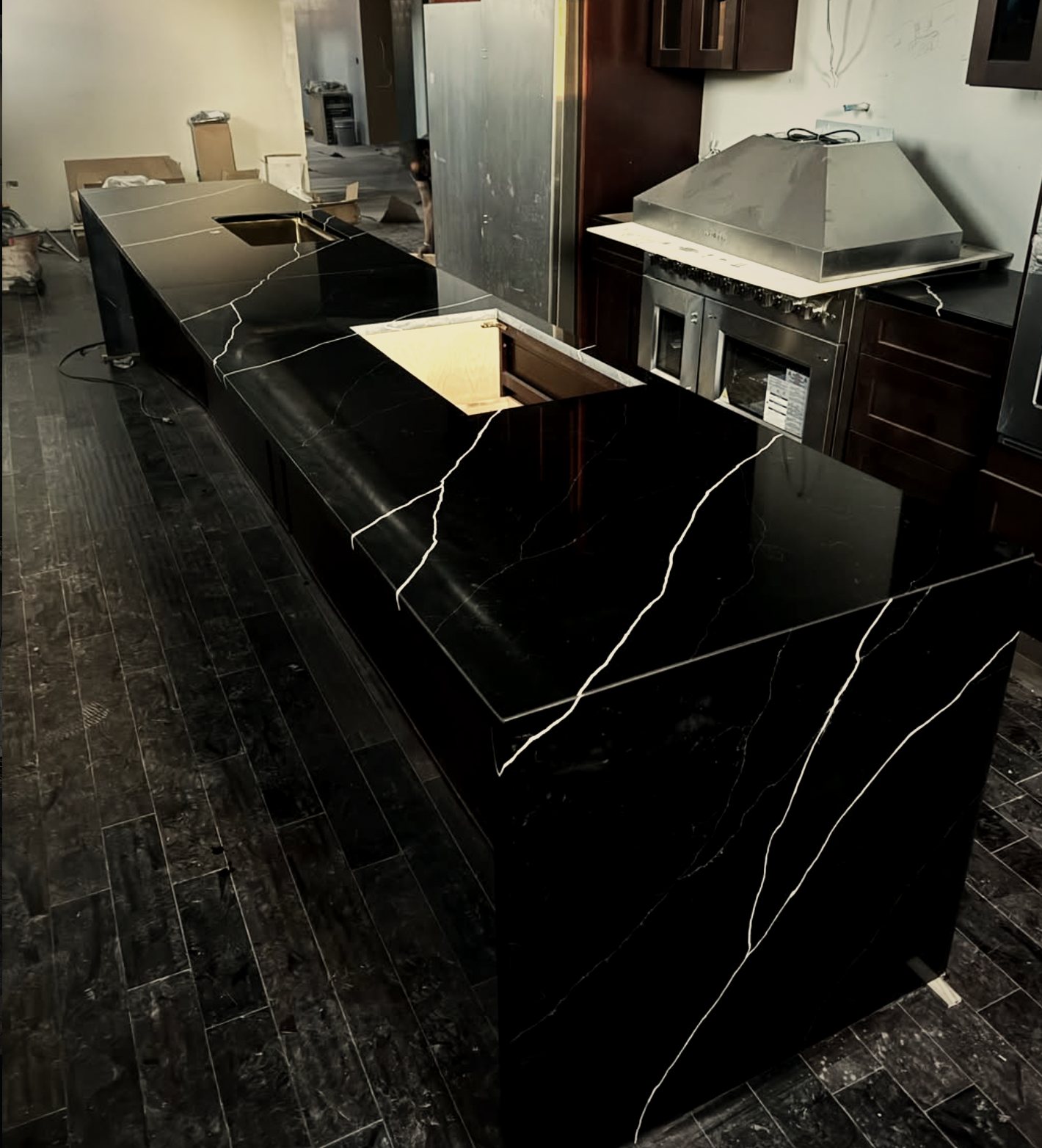 Black quartz waterfall island with white veining